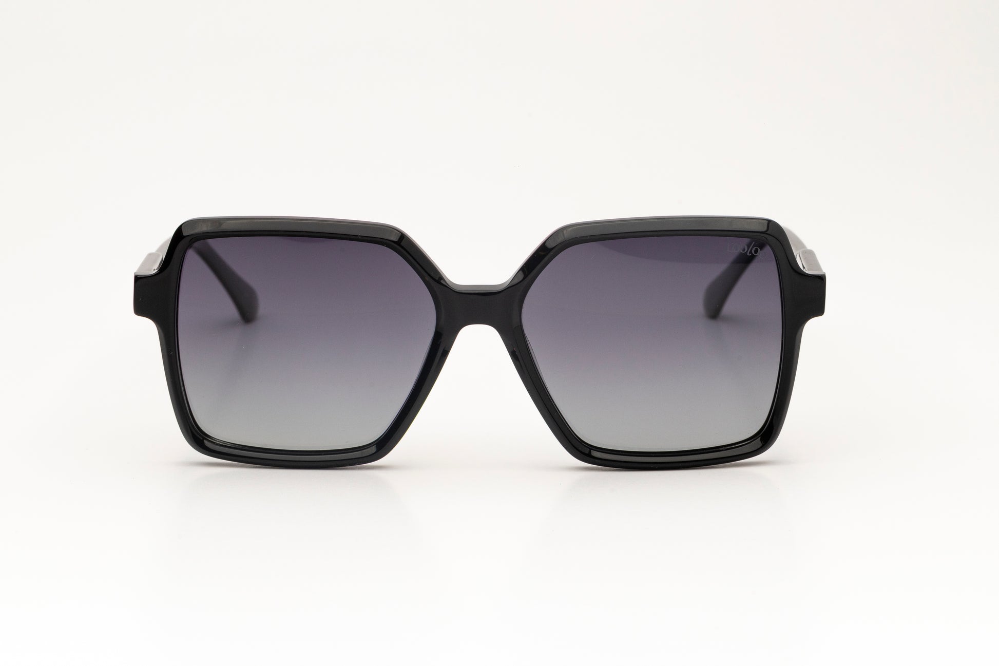 Sunglasses with black acetate frame with gradient lenses, on a white background.