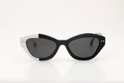 Sunglasses with black and white acetate frame on a white background.