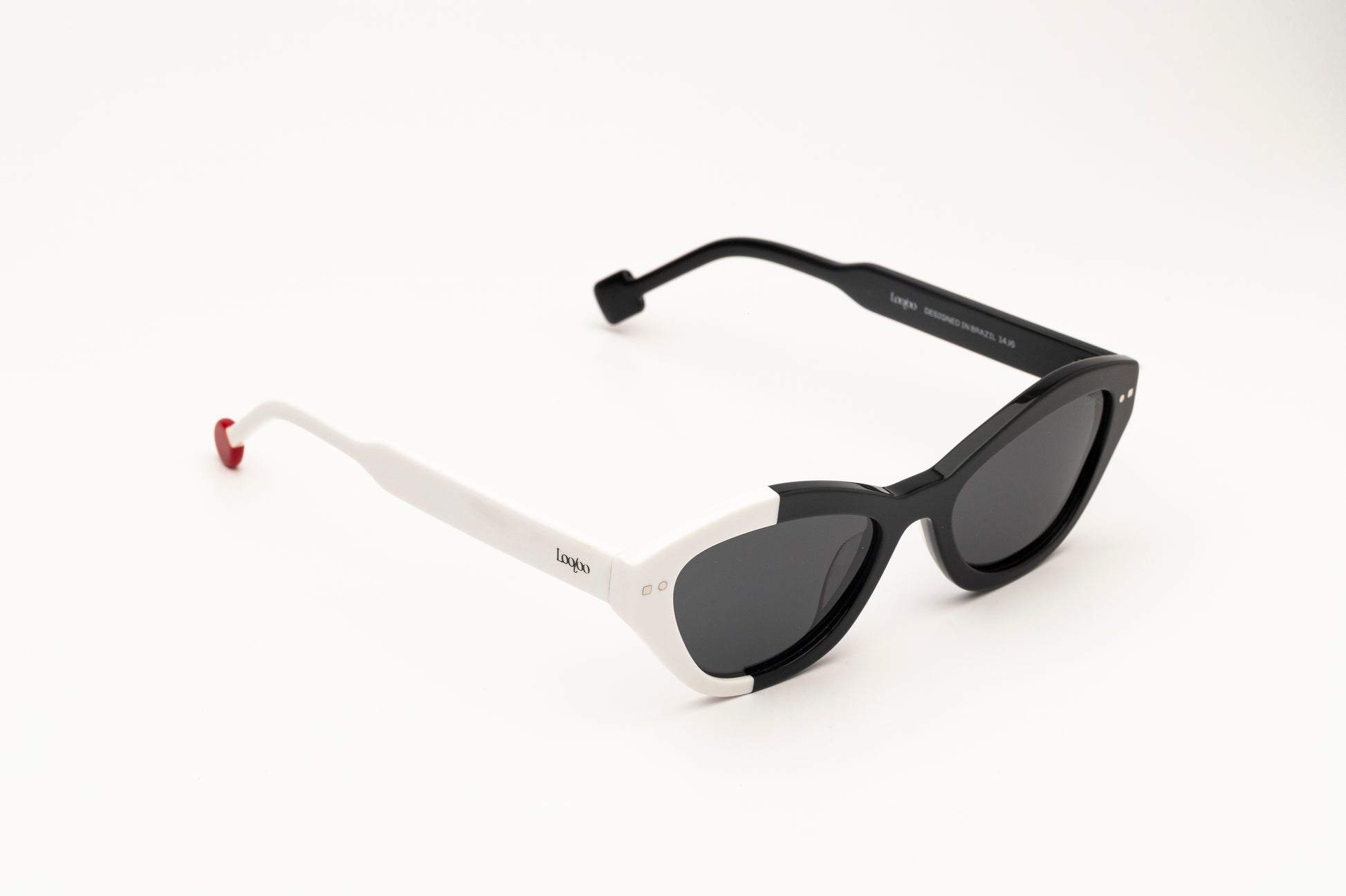Sunglasses with black and white acetate frame on a white background.