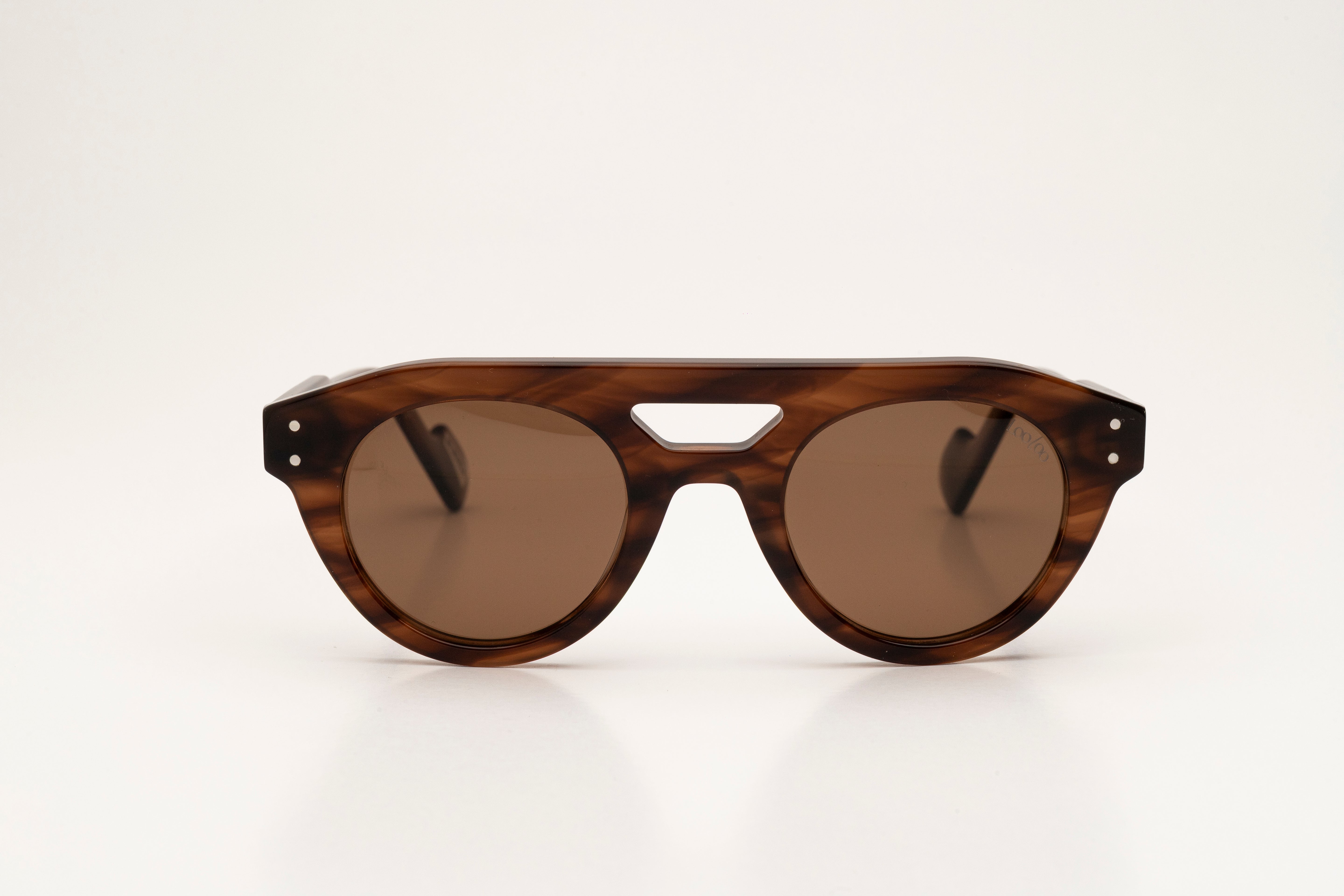 Sunglasses with tortoise acetate frame and brown lenses, on a white background.