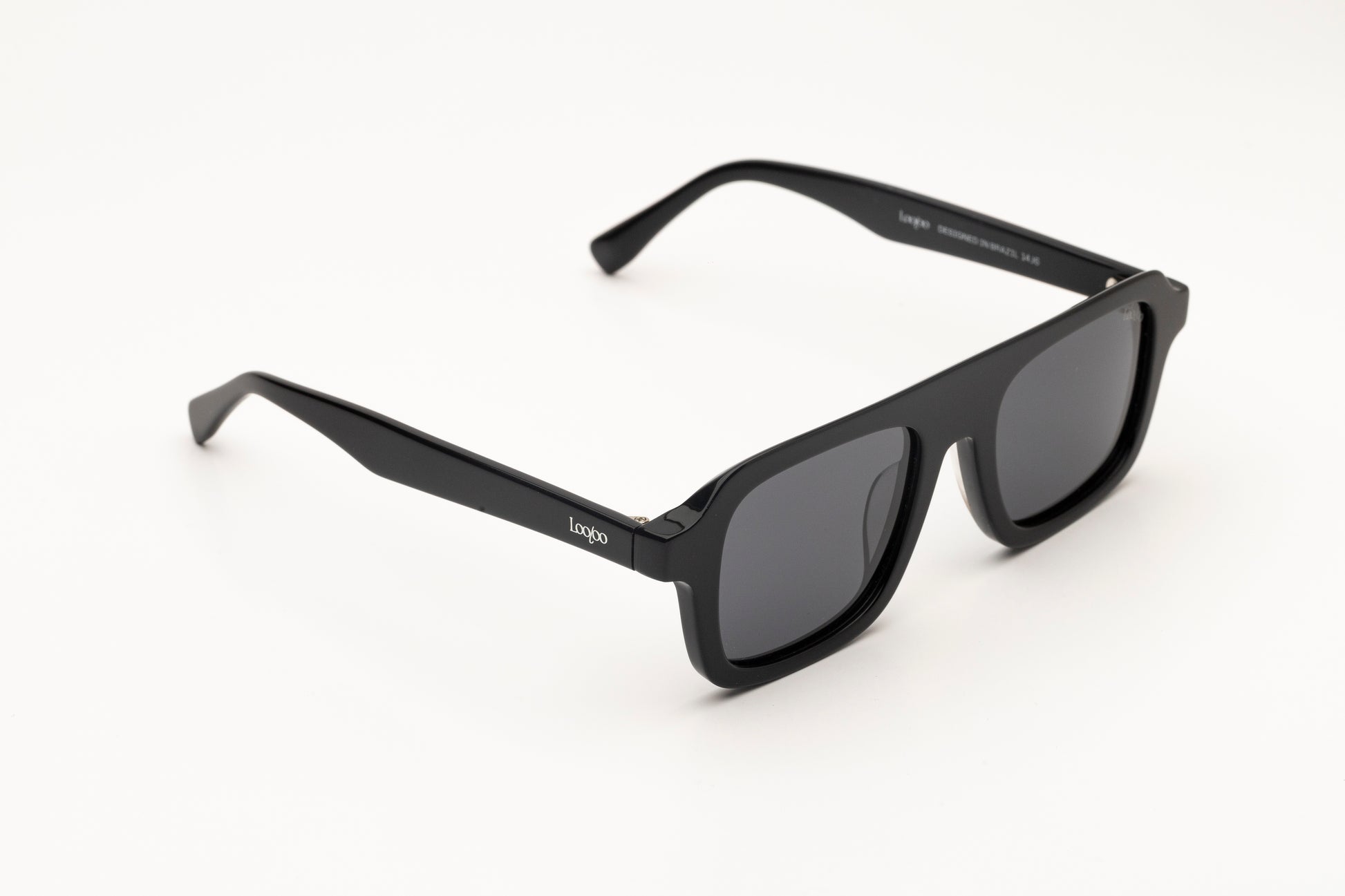 Sunglasses with black acetate frame on a white background.
