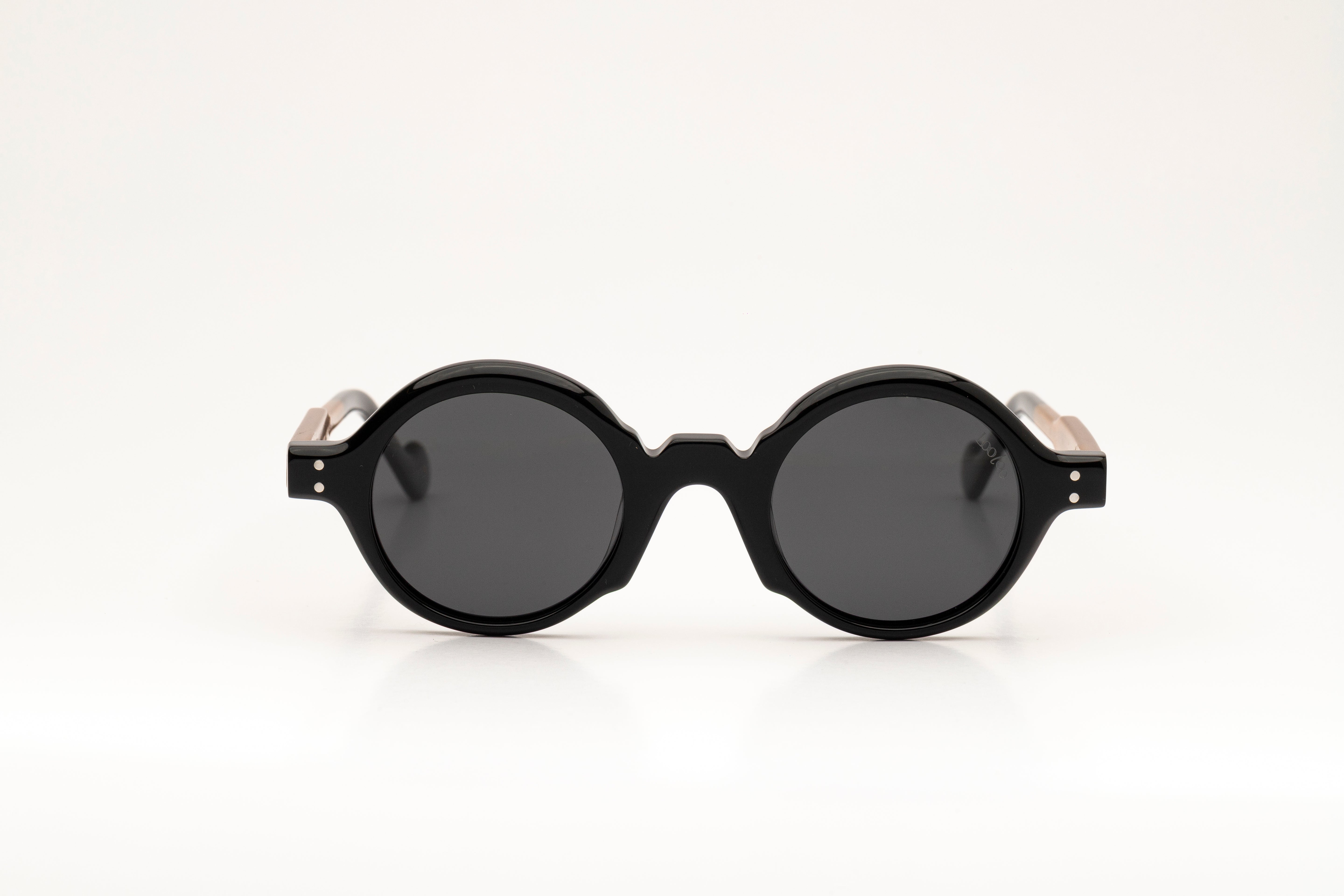 Sunglasses with black and brown acetate frame on a white background.
