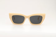 Sunglasses with beige acetate frame on a white background.