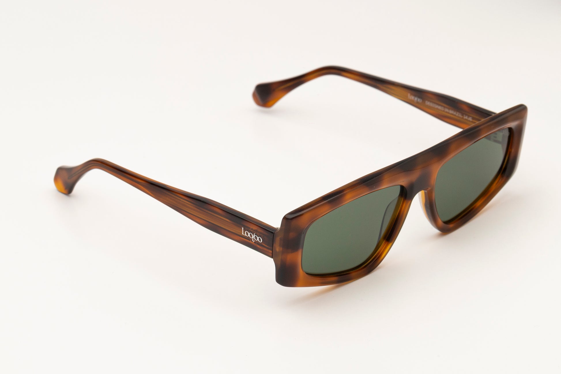 Sunglasses with tortoise acetate frame on a white background