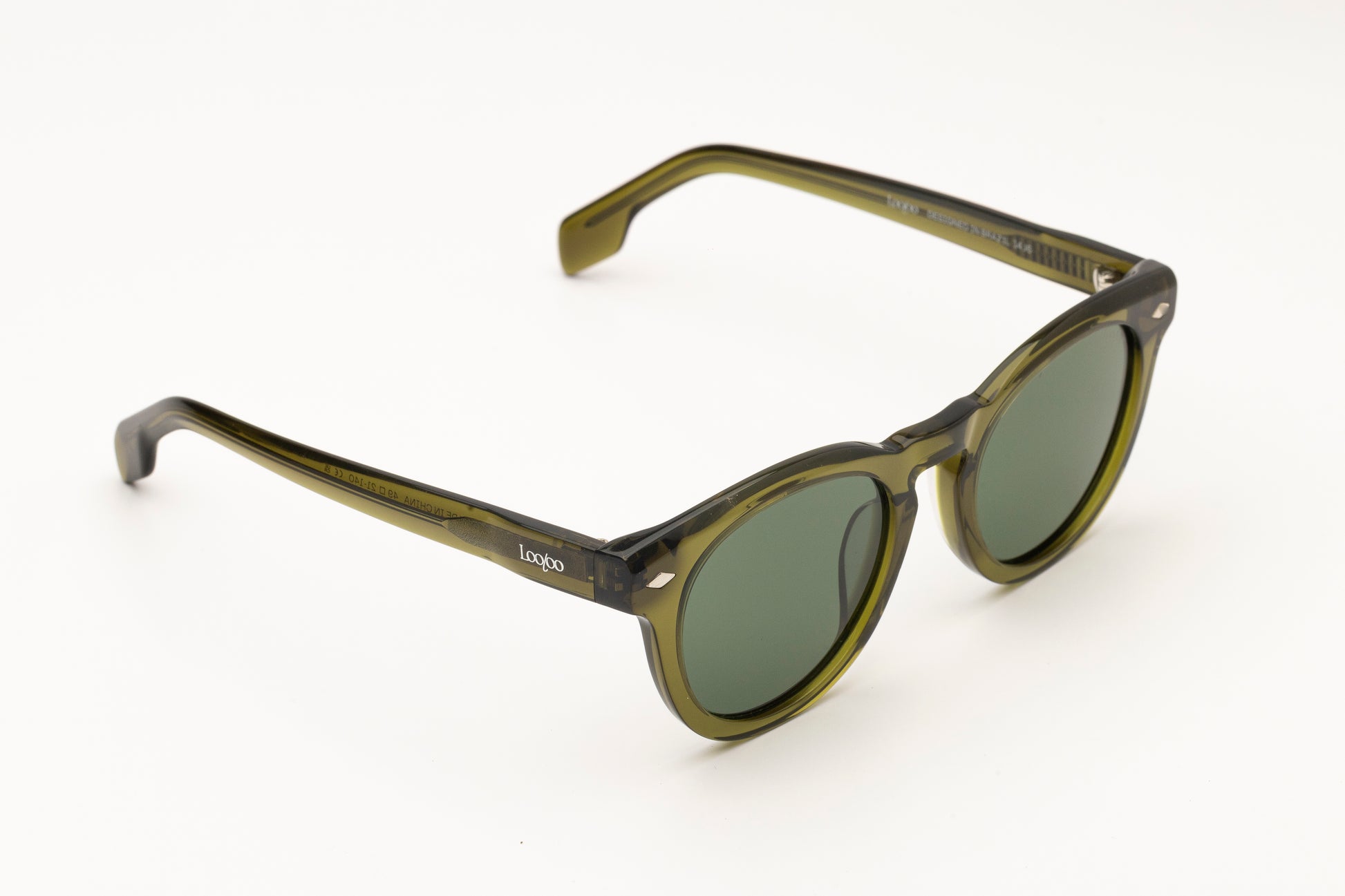 Sunglasses with green acetate frame and green lenses on a white background.