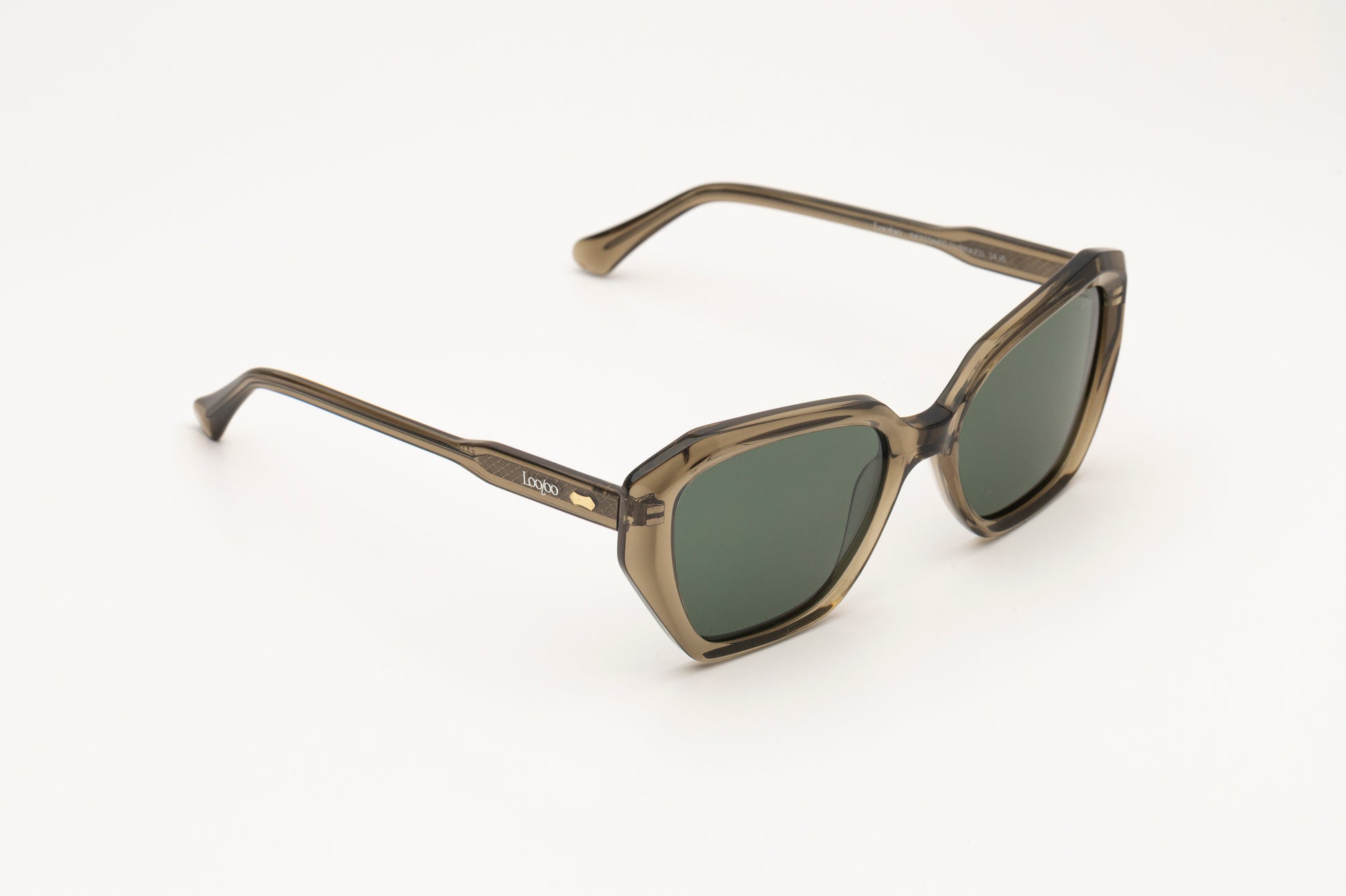 Sunglasses with green acetate frame and green lenses on a white background